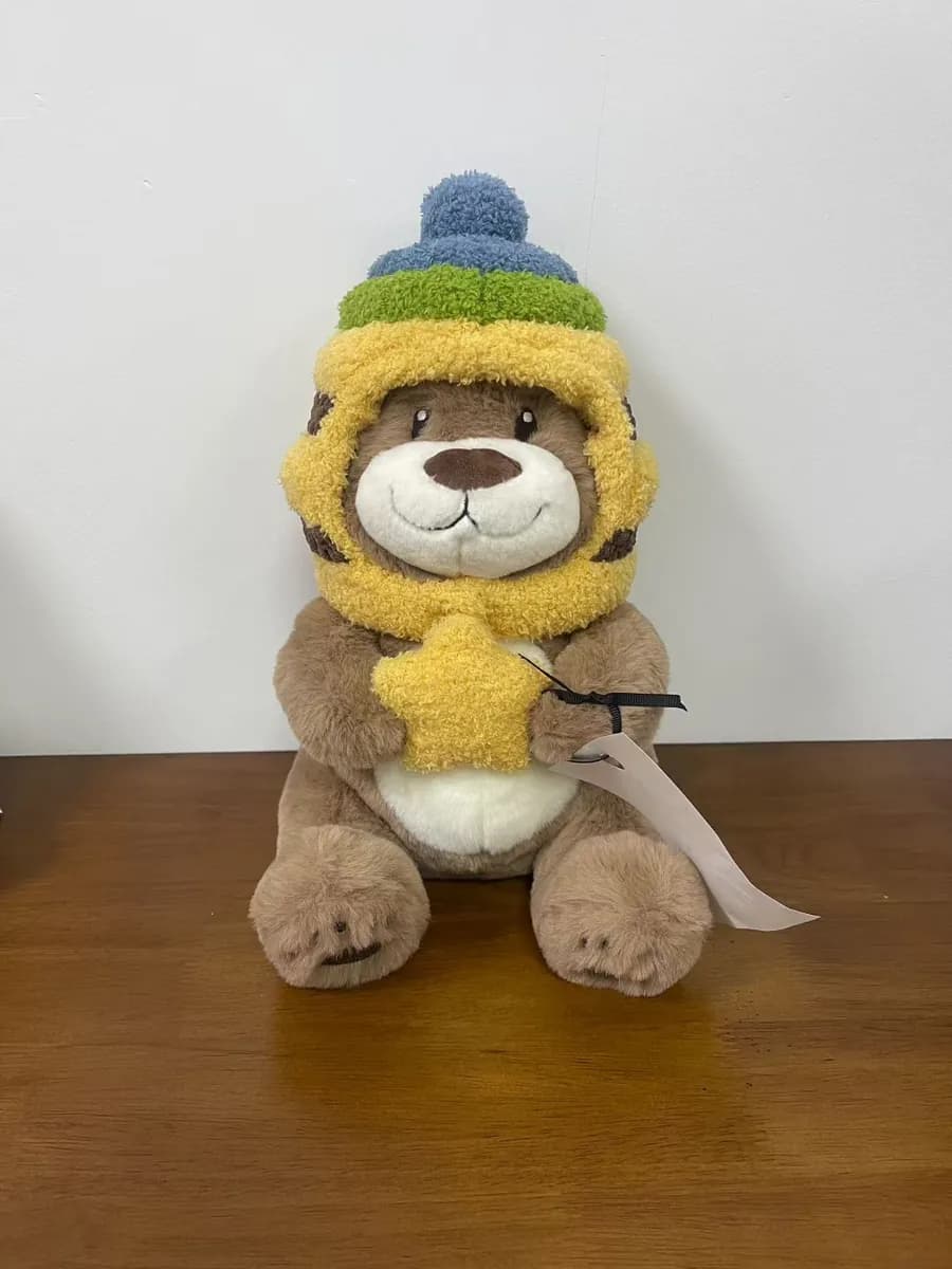 Bear plush toy in a knitted beanie and scarf