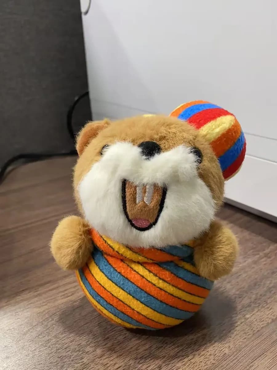Dog plush toy with a striped fabric ball