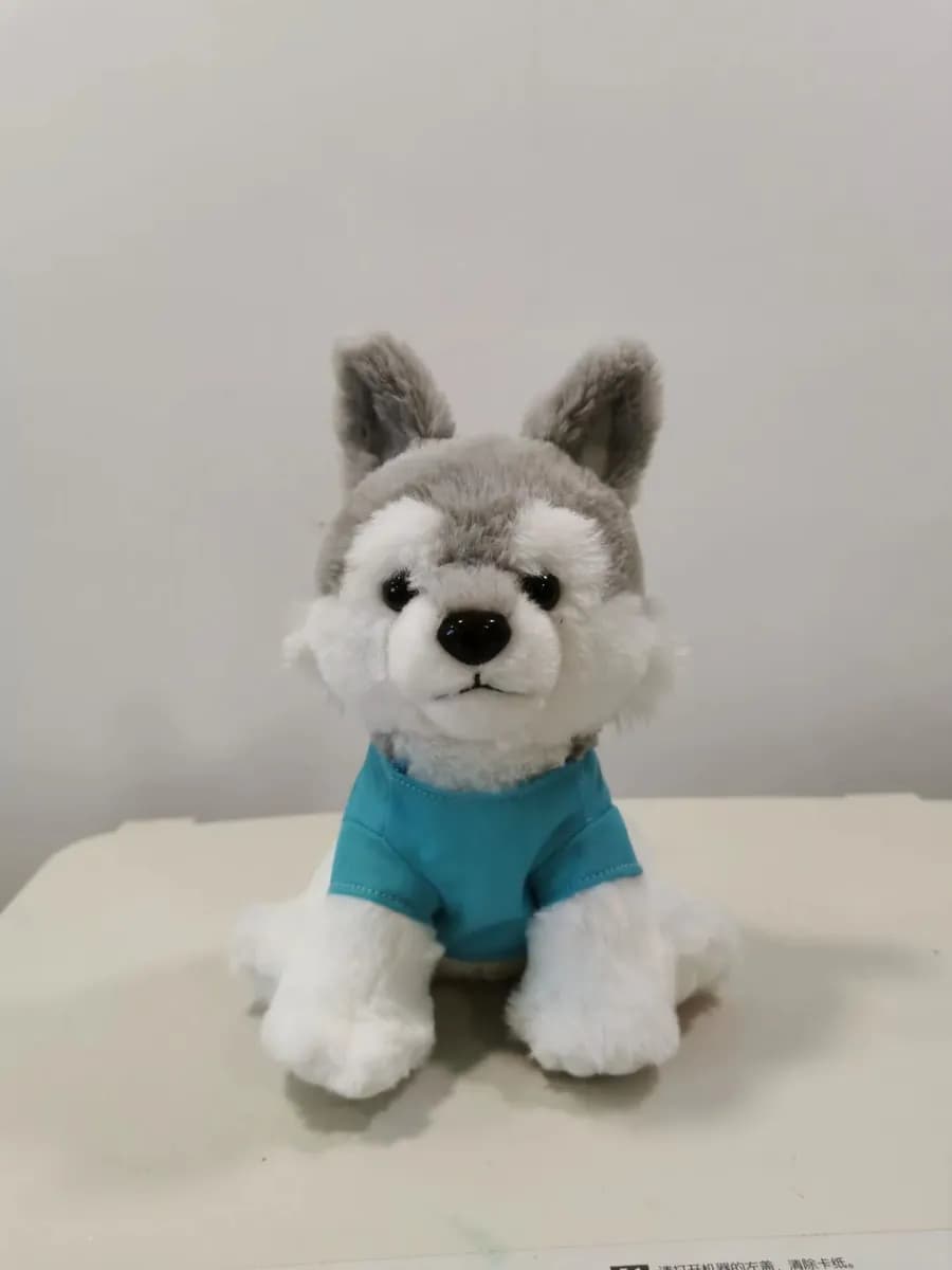 Husky puppy plush toy wearing a teal knitted top