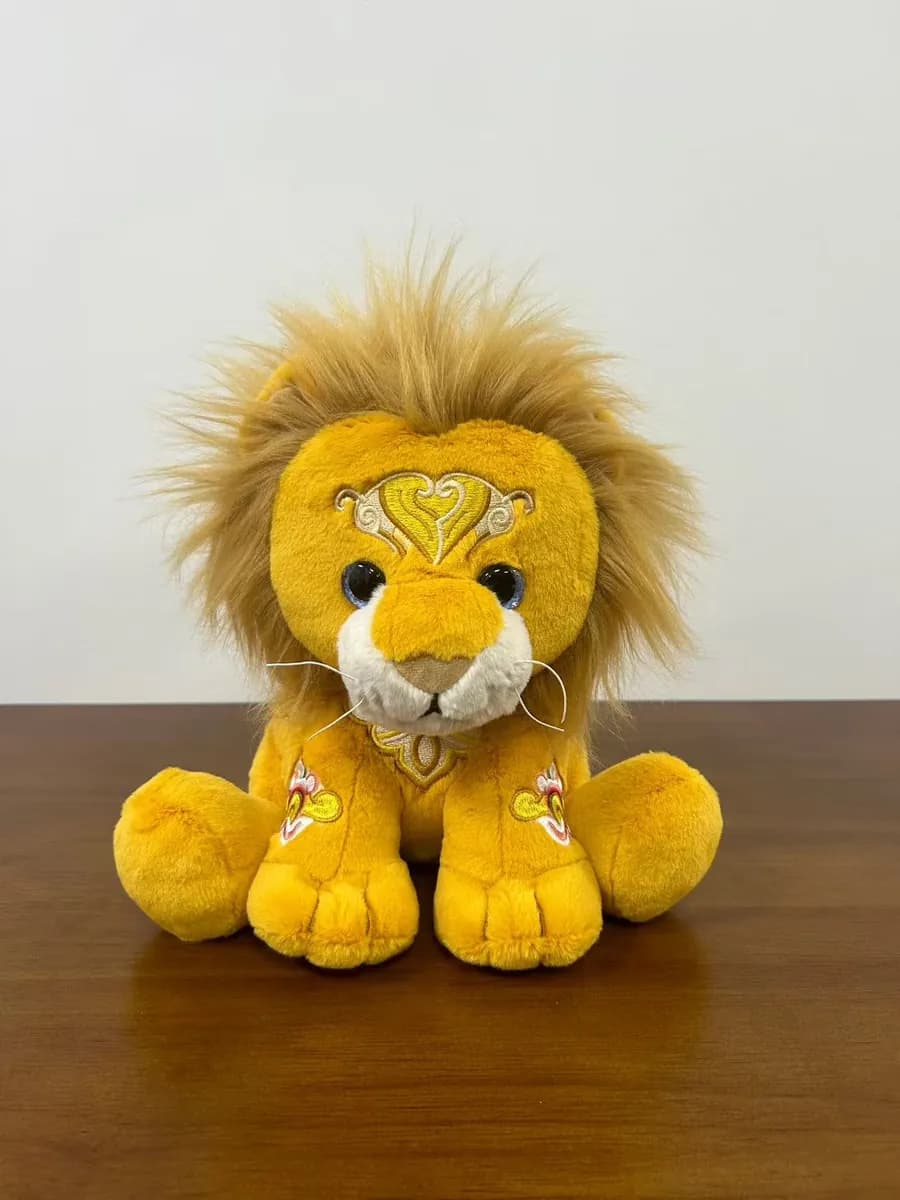 Small lion plush toy with a dense orange mane