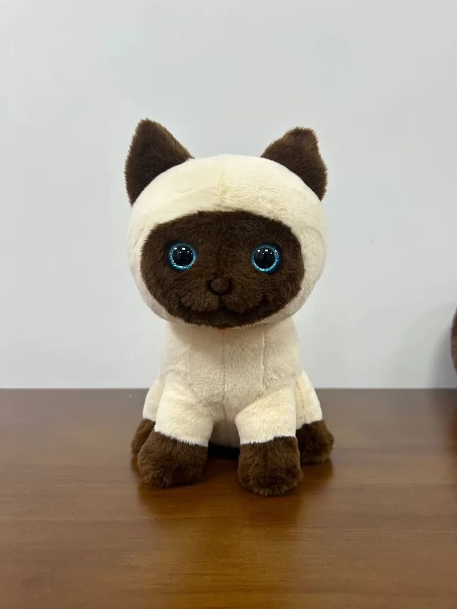 Siamese cat plush toy with embroidered blue eyes and a hood