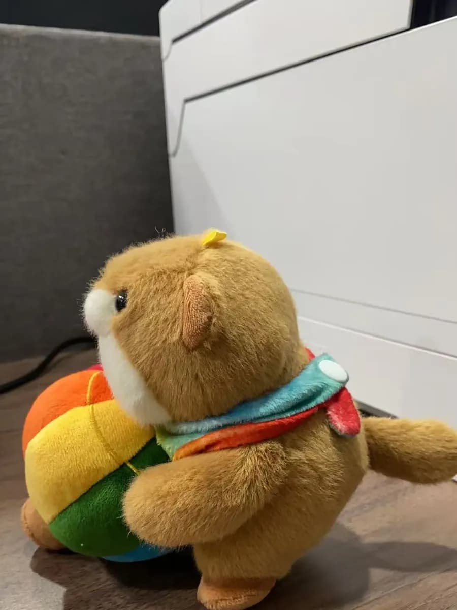 Bear plush toy dressed as a burger with rainbow filling
