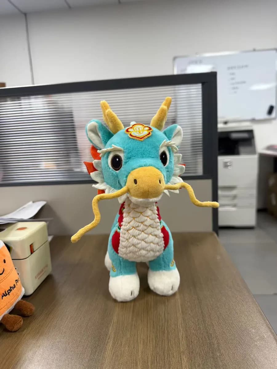 Dragon character plush toy with metallic accent fabric