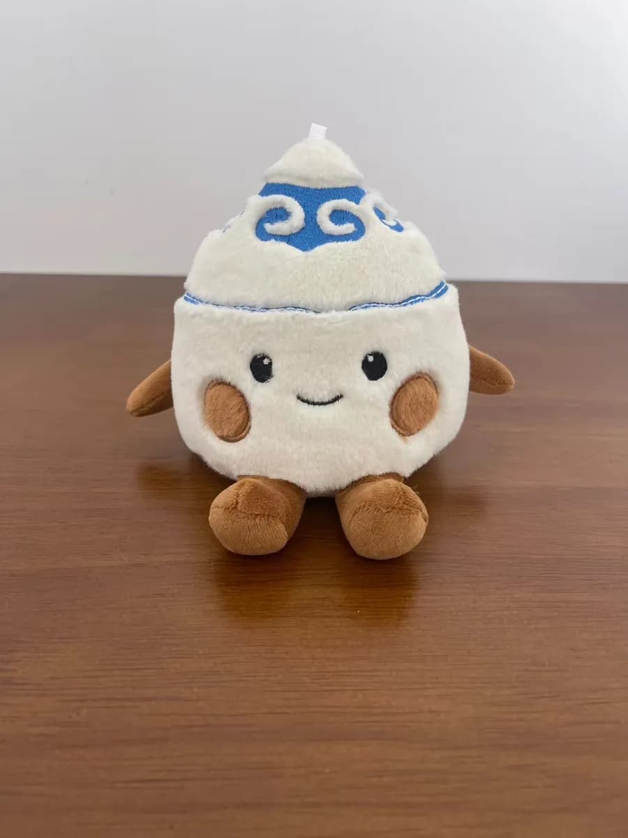 Dumpling plush toy wearing an embroidered chef hat