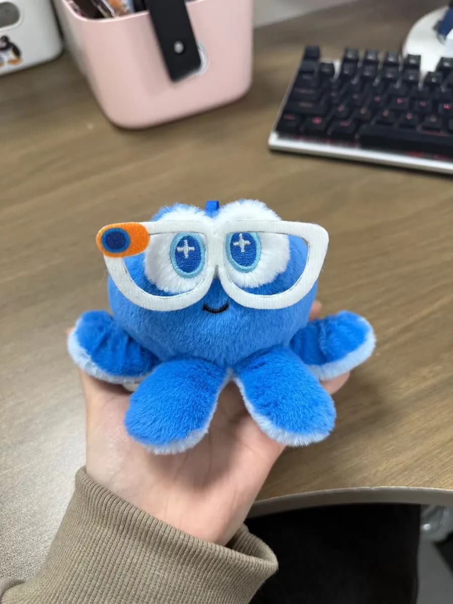 Blue monster plush toy with oversized appliqué eyes
