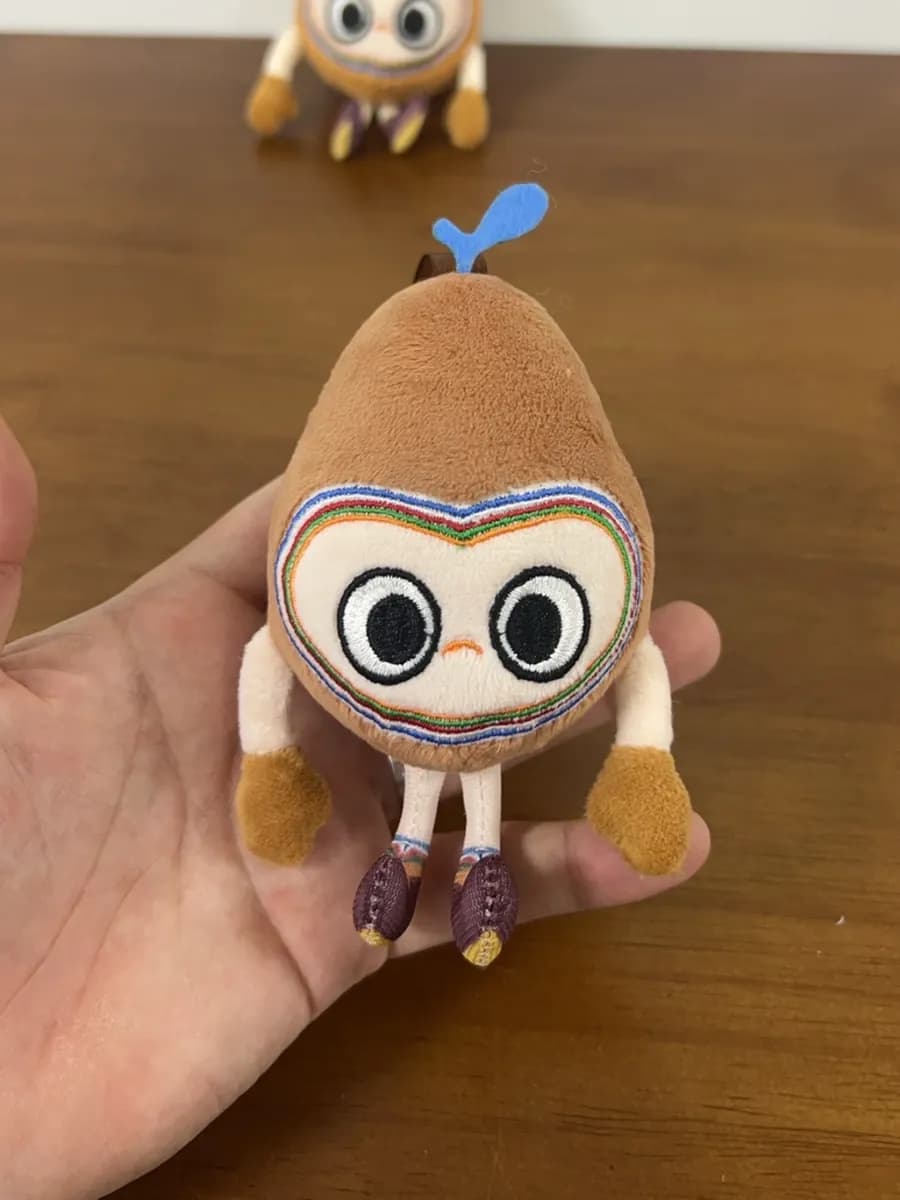Collectible owl character plush with appliqué eyes