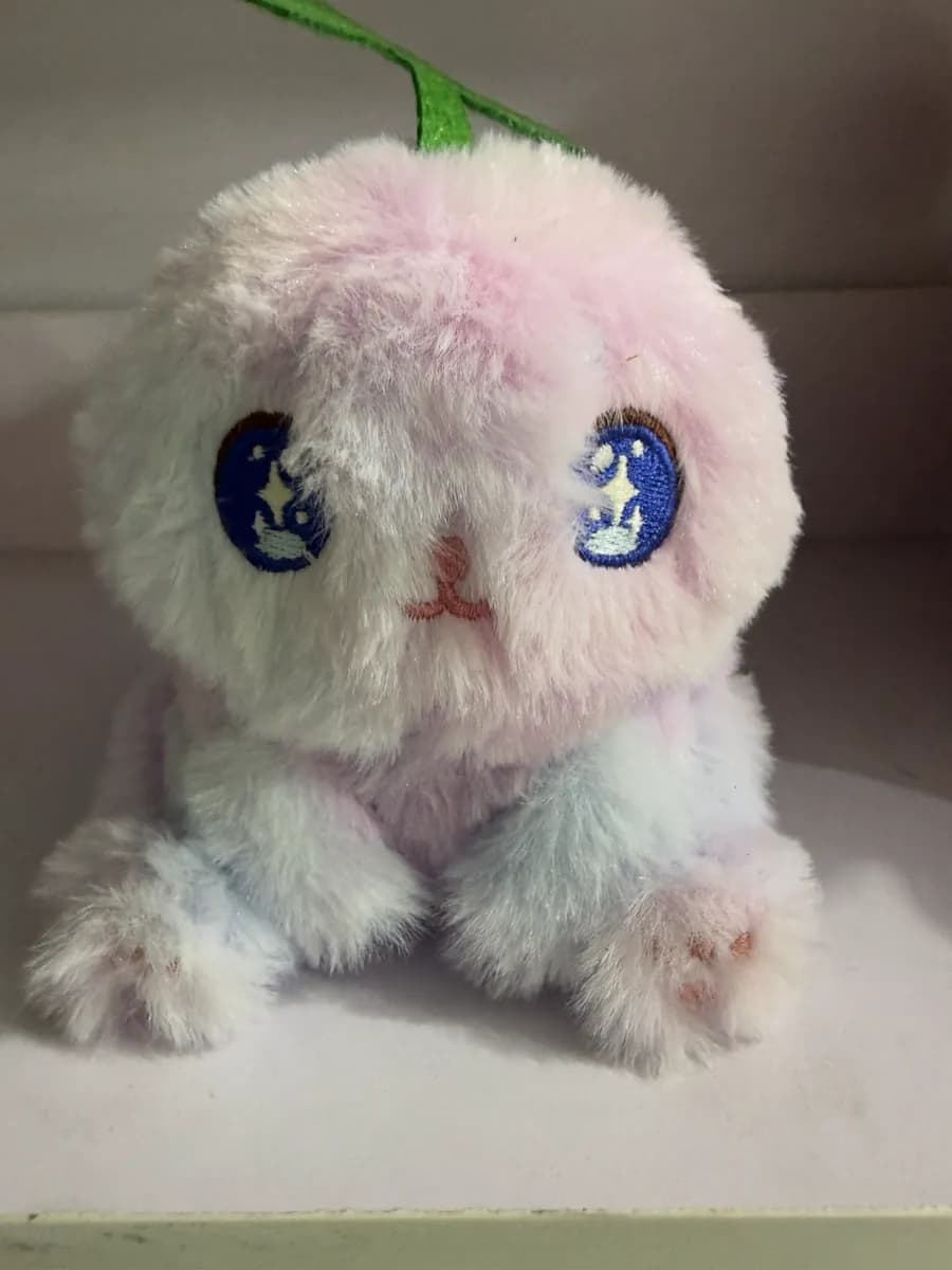 Fluffy cotton doll with hand-embroidered eyes in pastel fur