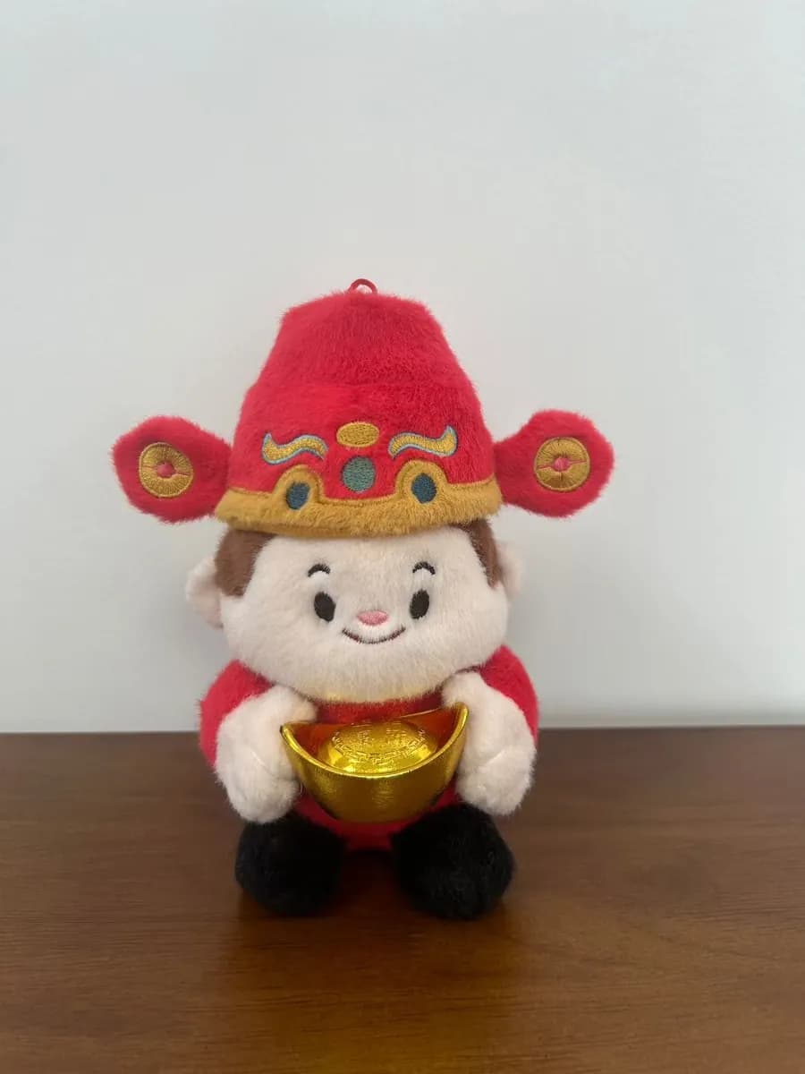 Traditional fortune character doll with a hat and robe