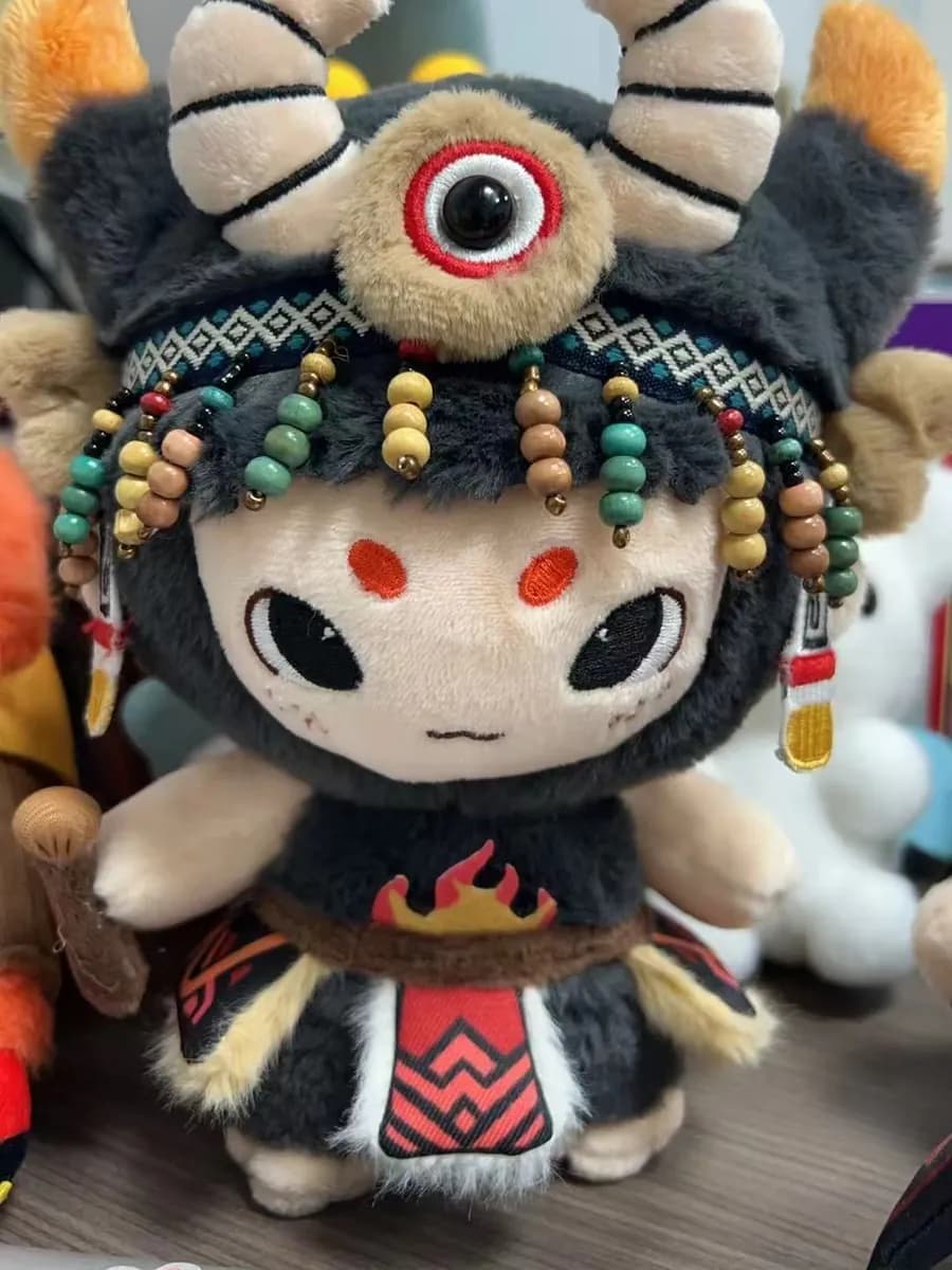 Opera character doll with a beaded headdress and printed costume