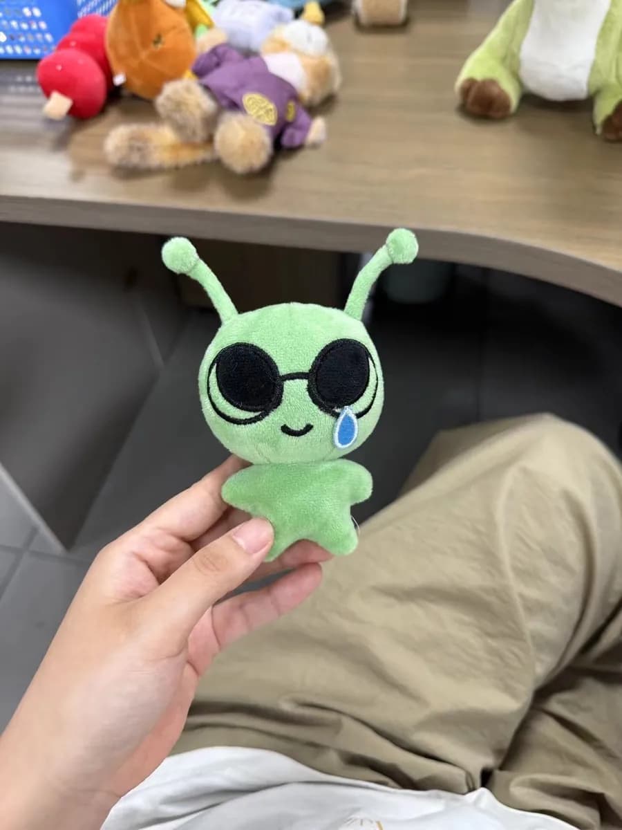 Green alien plush keychain with appliqué eyes