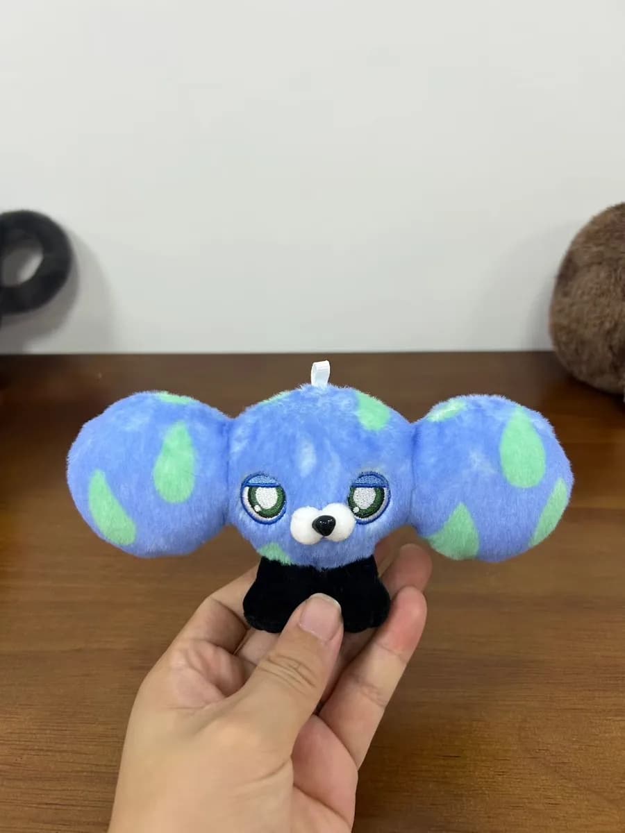 Blue globe plush charm with an embroidered animal face