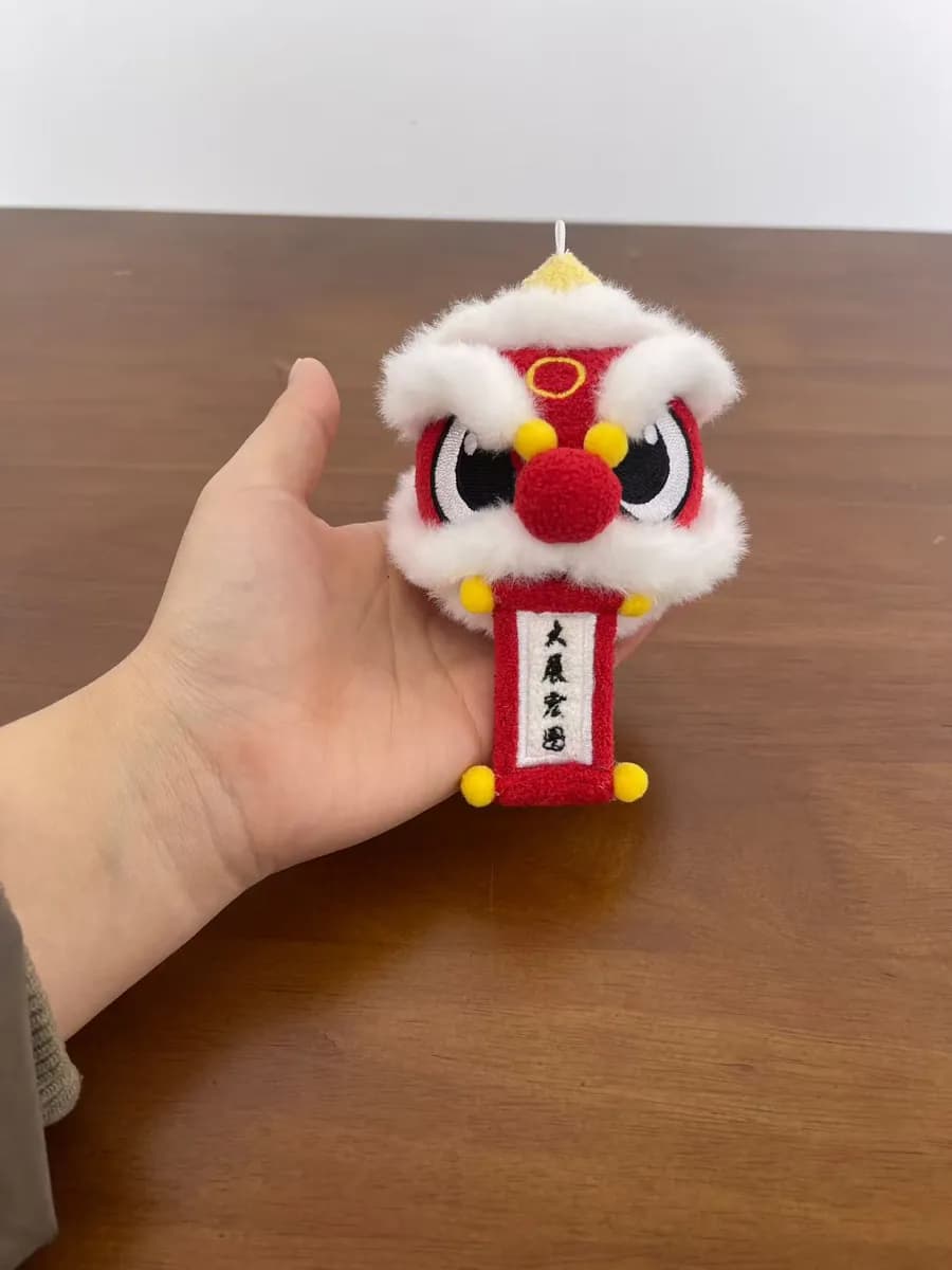 Lion dance plush keychain with red and gold appliqué