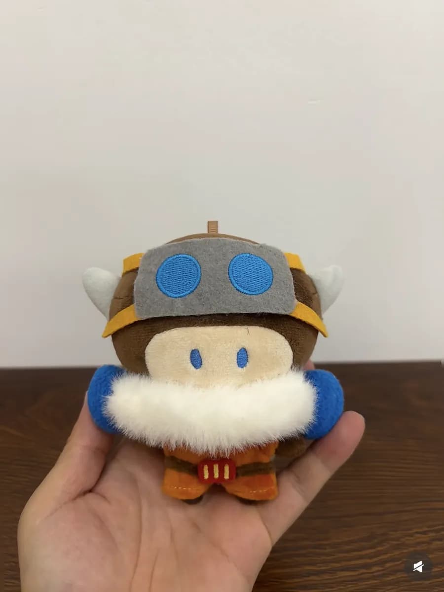 Character mascot plush with a moulded blue helmet