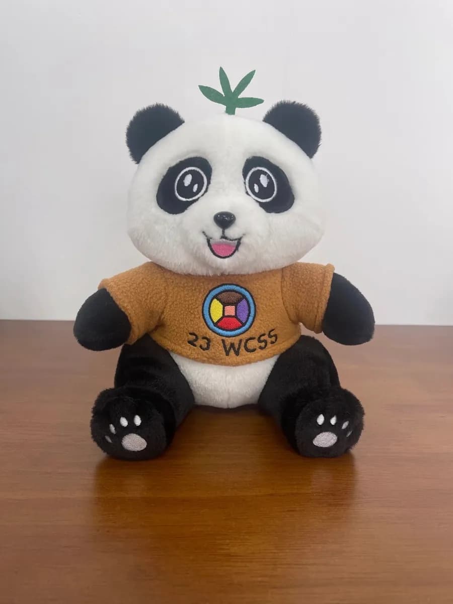 Panda mascot plush toy with a printed event logo on the shirt